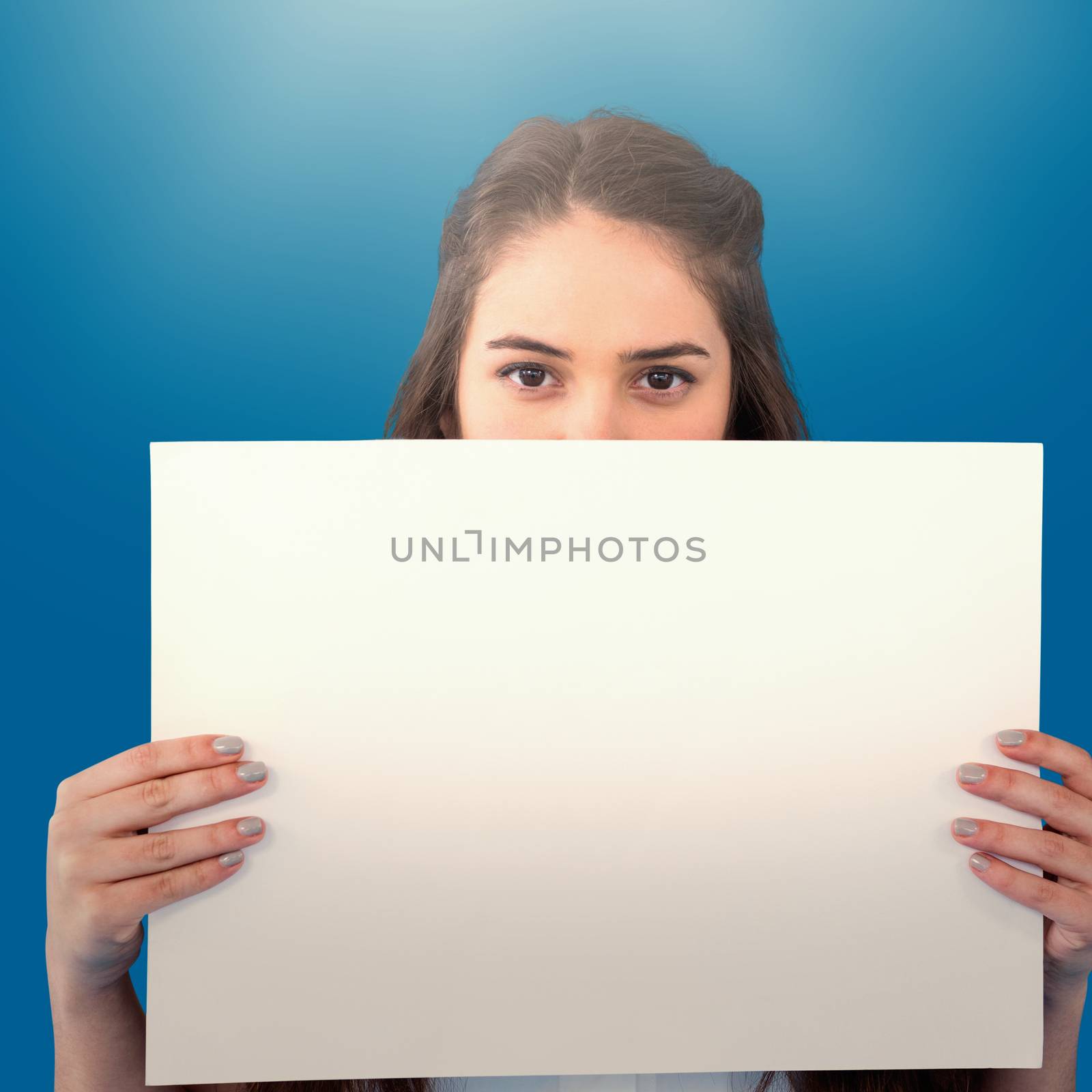 Women holding blank poster  against royal blue