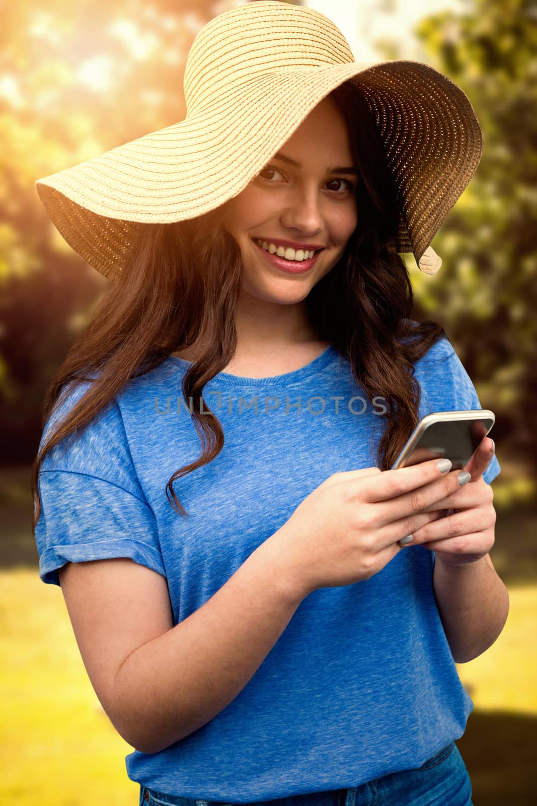 Composite image of brunette women wearing summer hat  by Wavebreakmedia