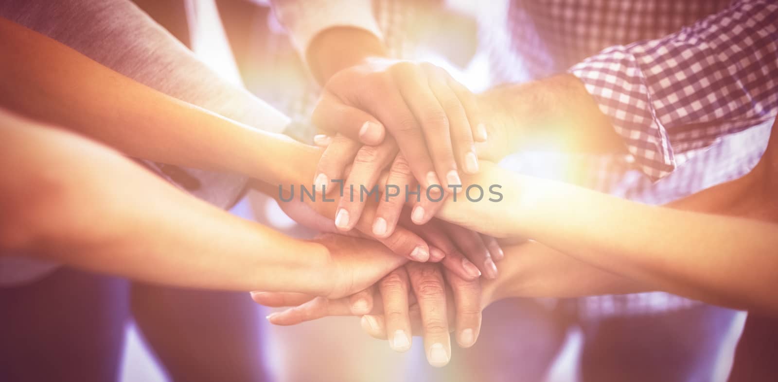 Cropped image of business people stacking hands by Wavebreakmedia