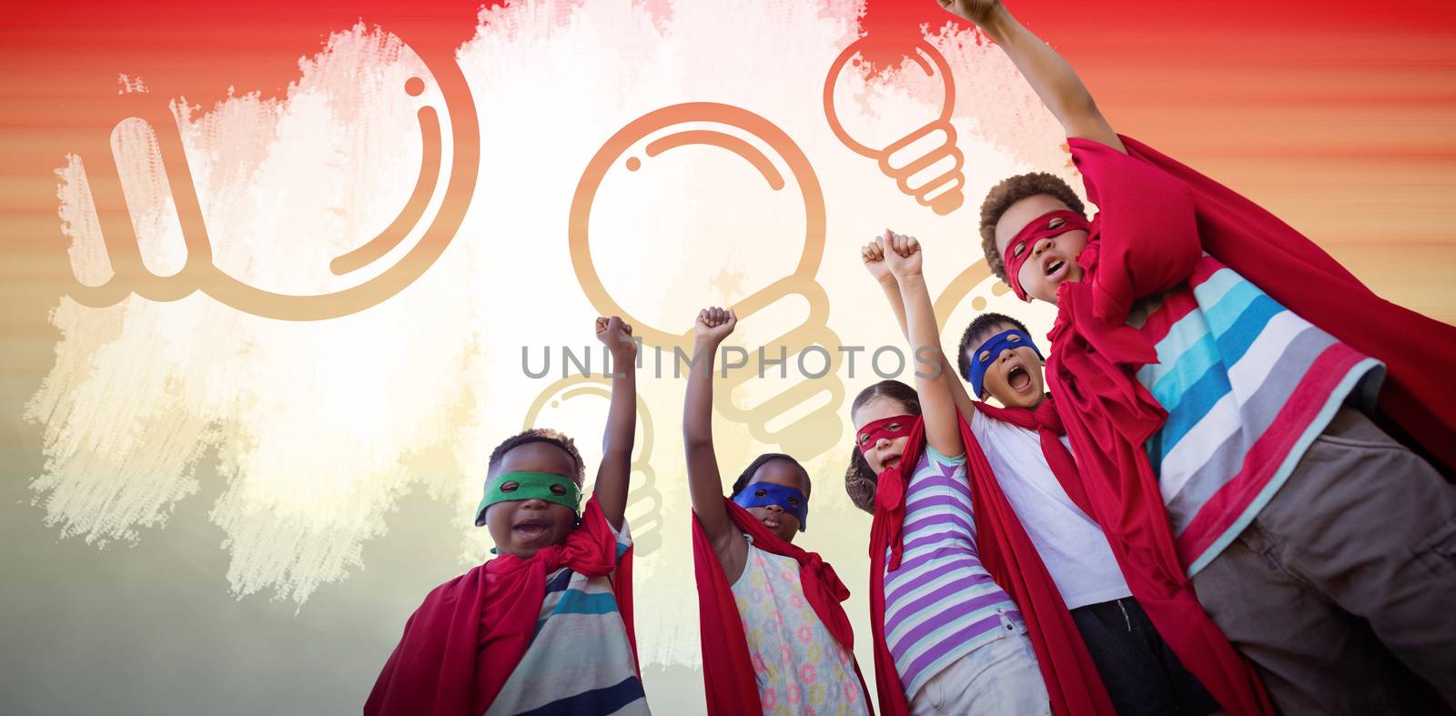 Low angle view of children in superhero costumes against orange and yellow abstract backgrounds