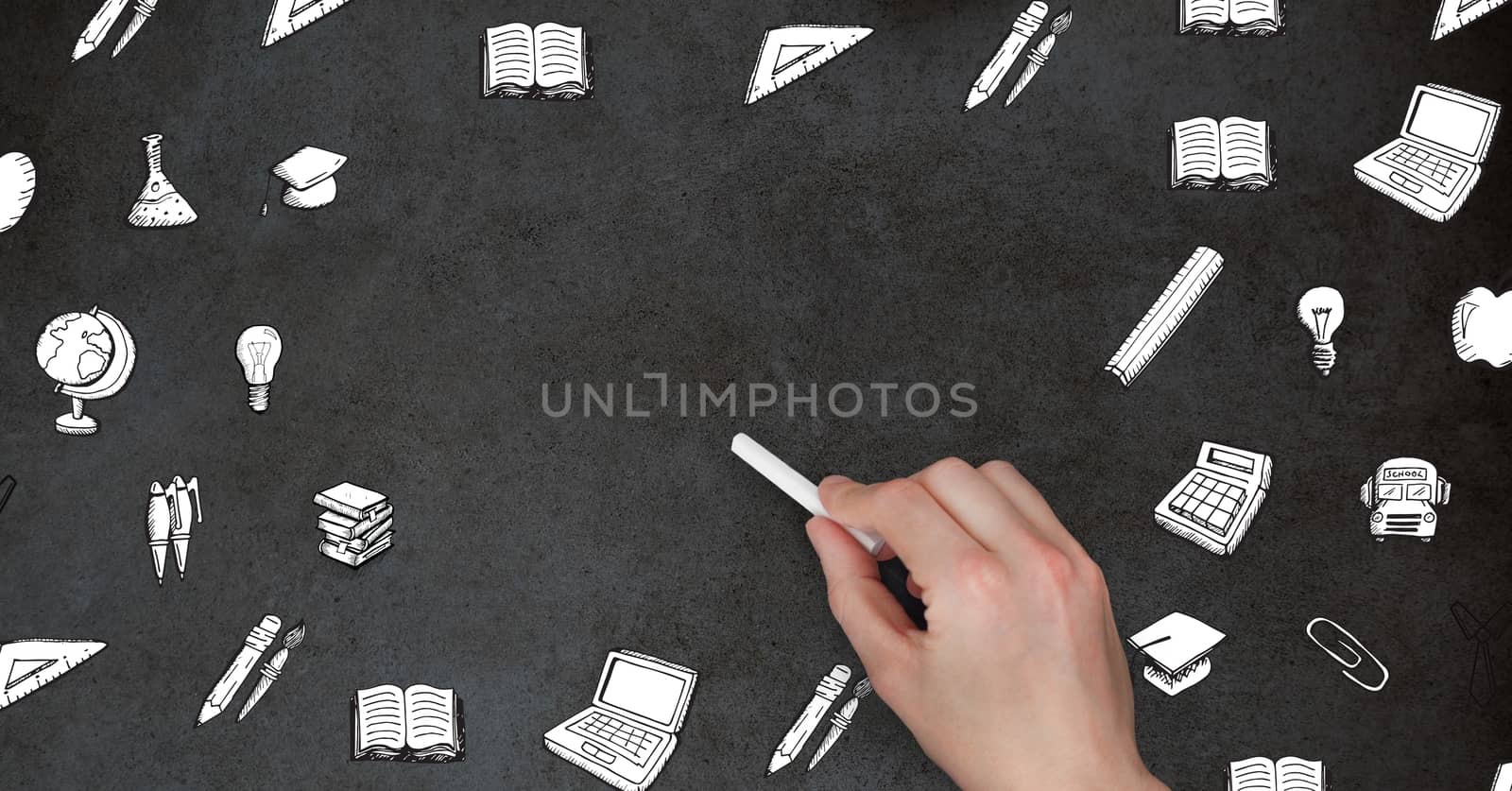 Digital composite of Hand holding chalk surrounded by education graphics on blackboard