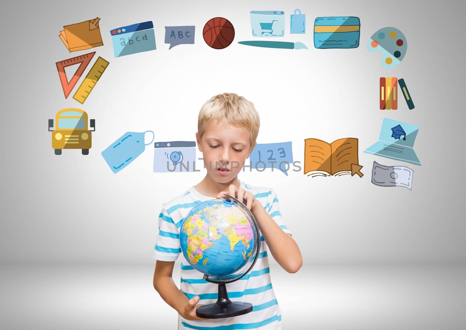 Digital composite of Boy holding world globe in front of education graphics