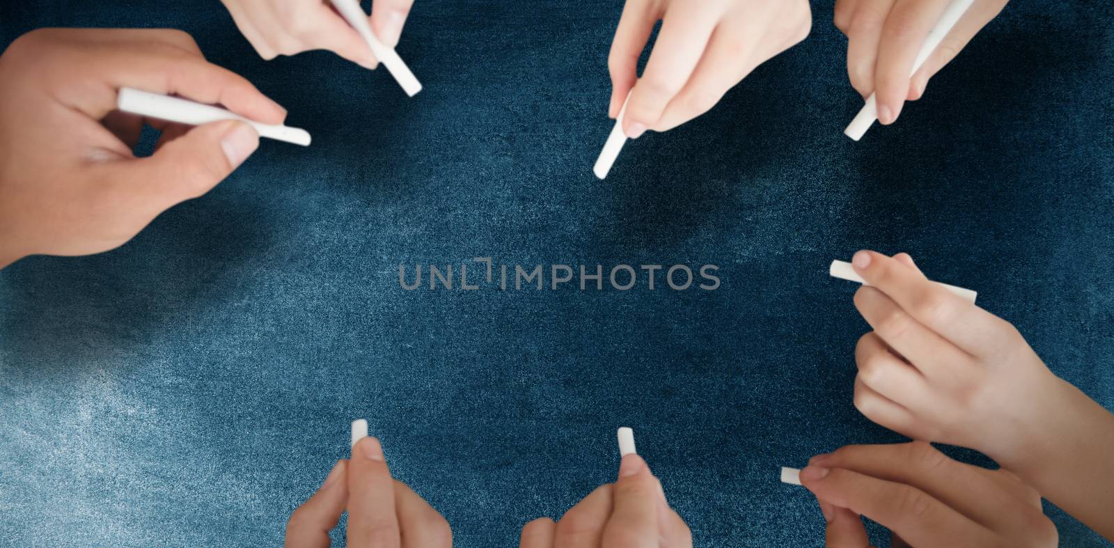 Composite image of business people writing with chalks by Wavebreakmedia