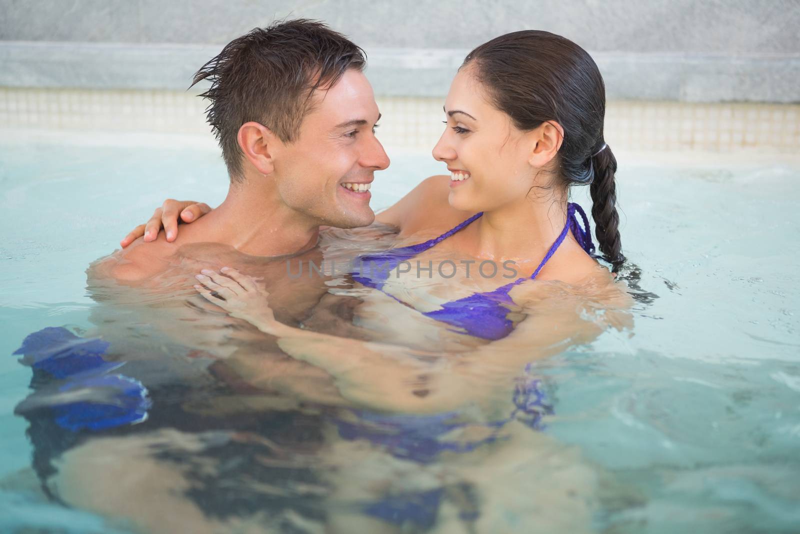 Close up of a romantic young couple in swimming pool