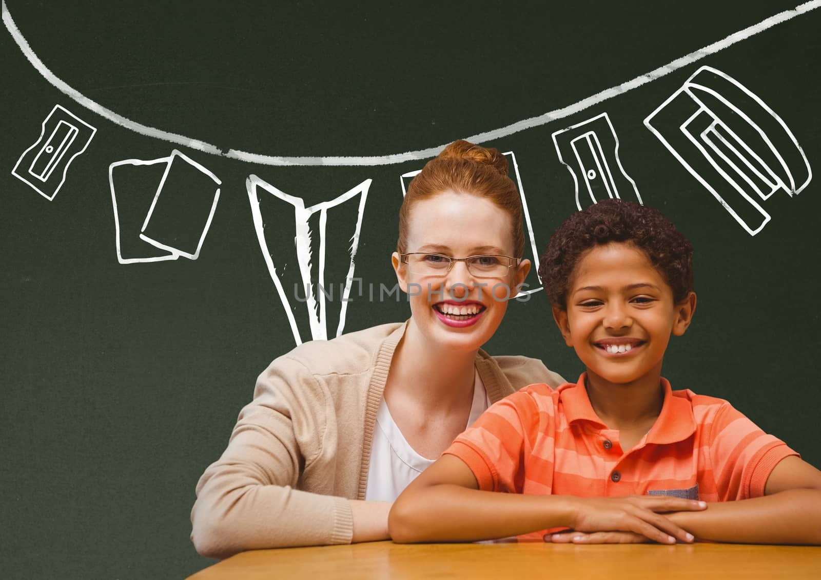 Student boy and teacher at table smiling against green blackboard with school and education graphic by Wavebreakmedia