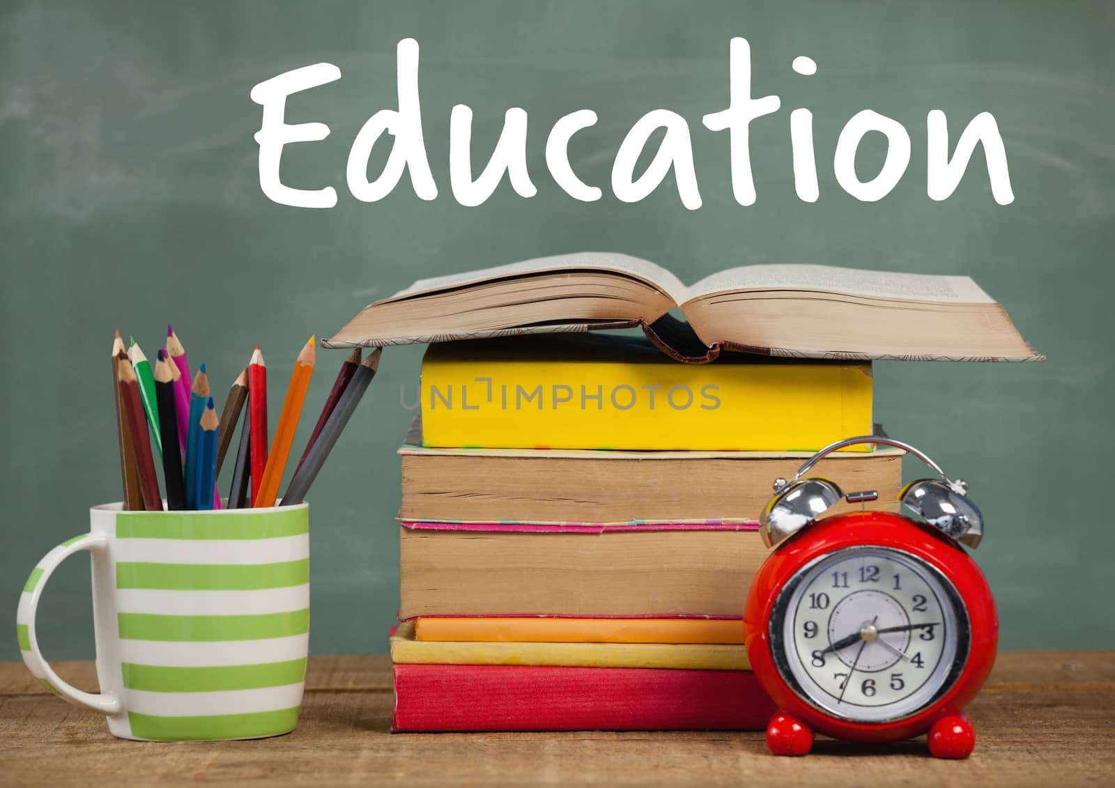 Digital composite of Books on Desk foreground with blackboard Education text