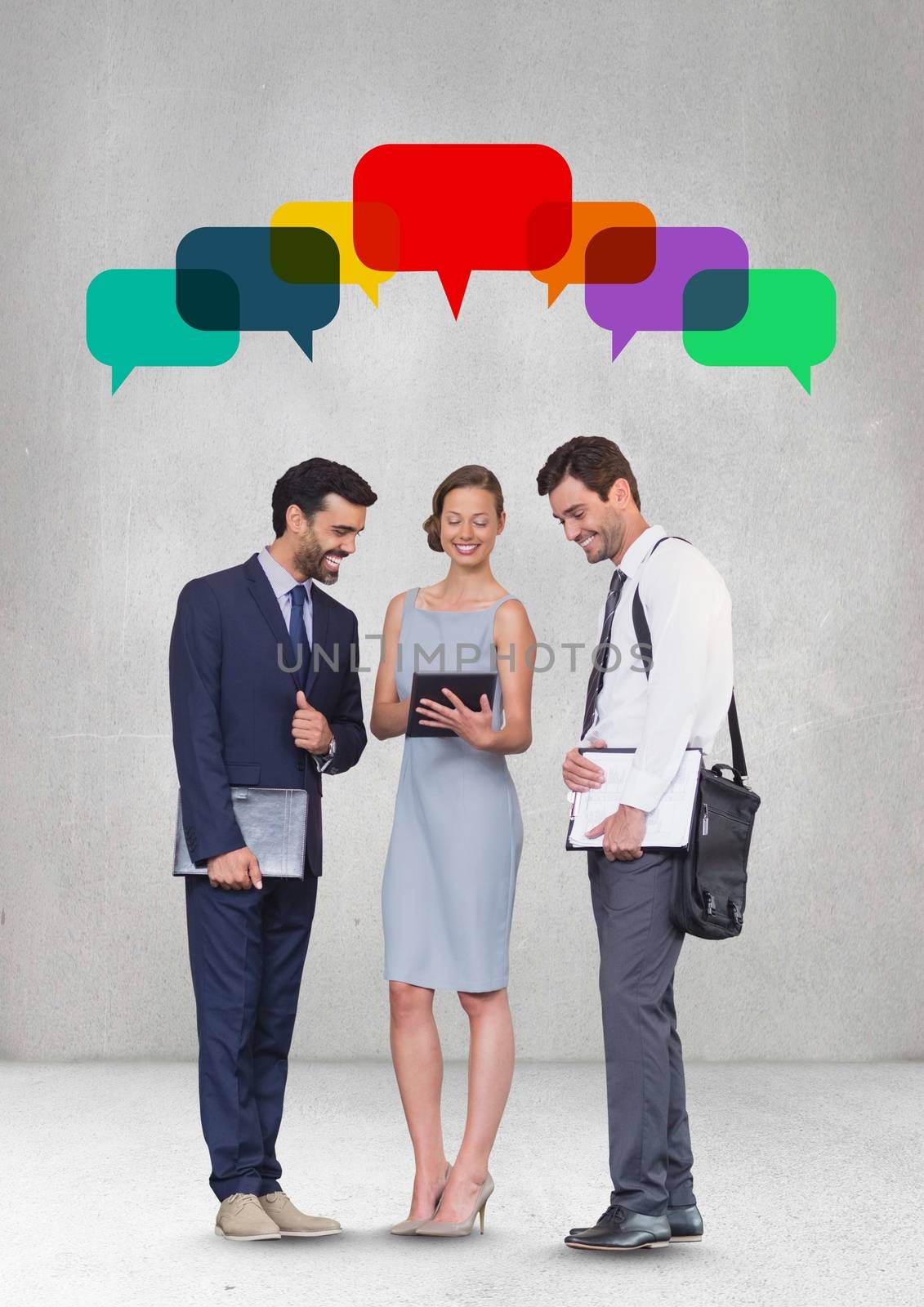 Business people with speech bubble looking at a tablet against grey background by Wavebreakmedia