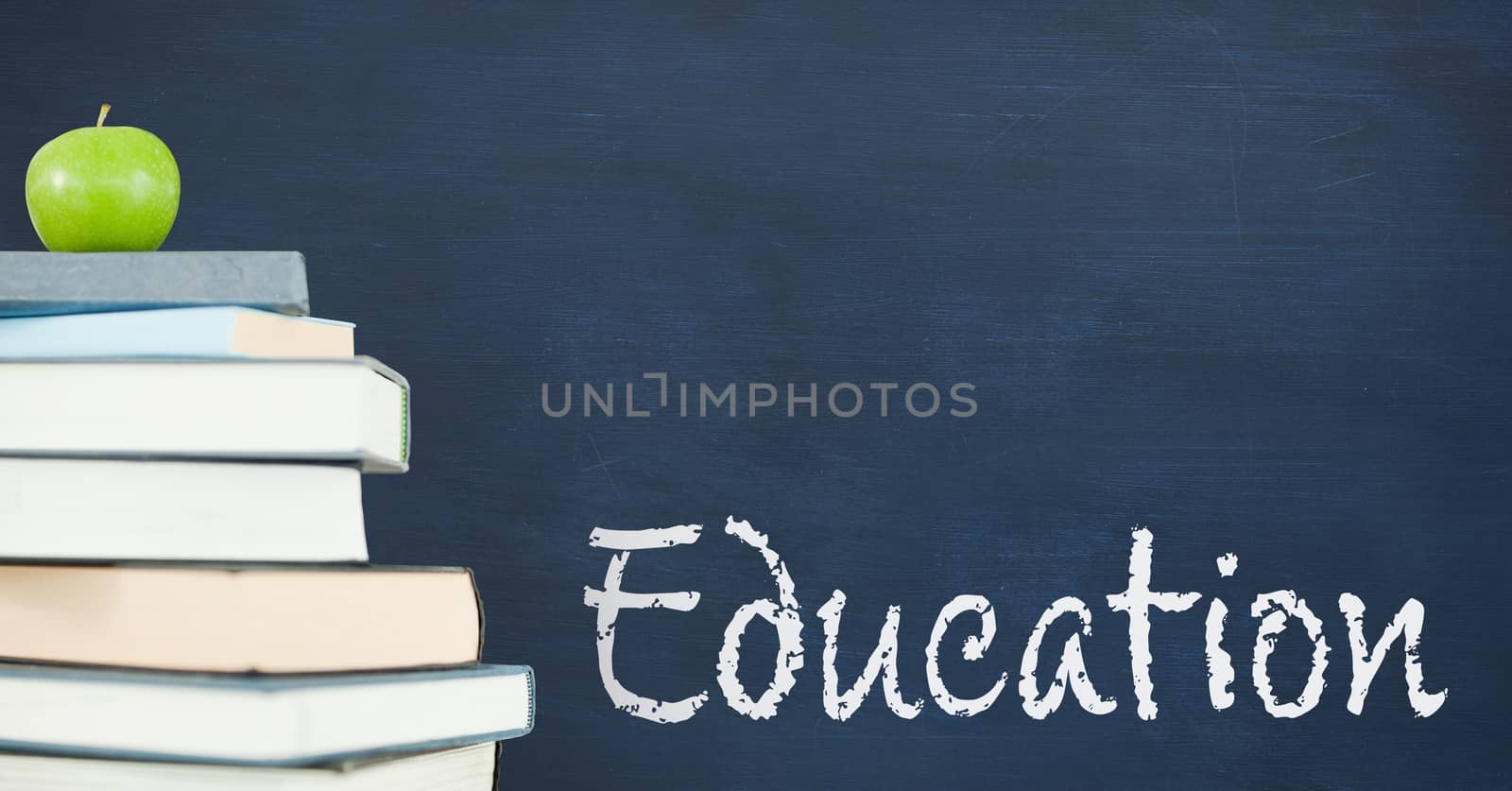 Books on the table against blue blackboard with education text by Wavebreakmedia