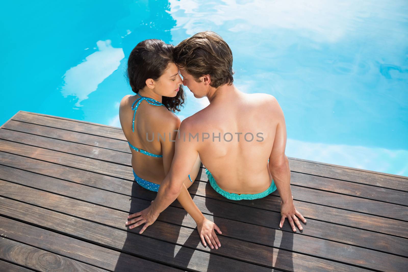 Romantic young couple by swimming pool by Wavebreakmedia