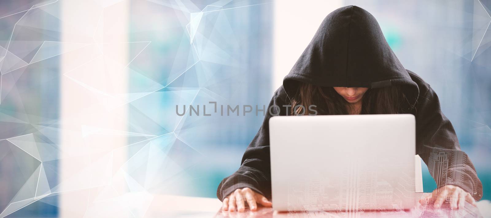 Female hacker sitting by laptop on table  against abstract glowing black background