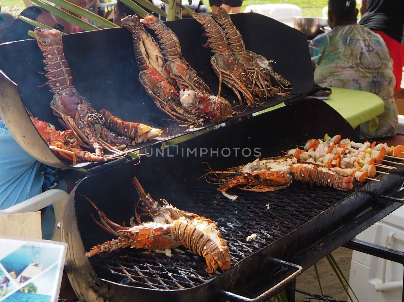 BBQ Lobster Placencia Lobster Festival, Belize, Caribbean. Bar Be Que for take away in plastic container. barbecue.