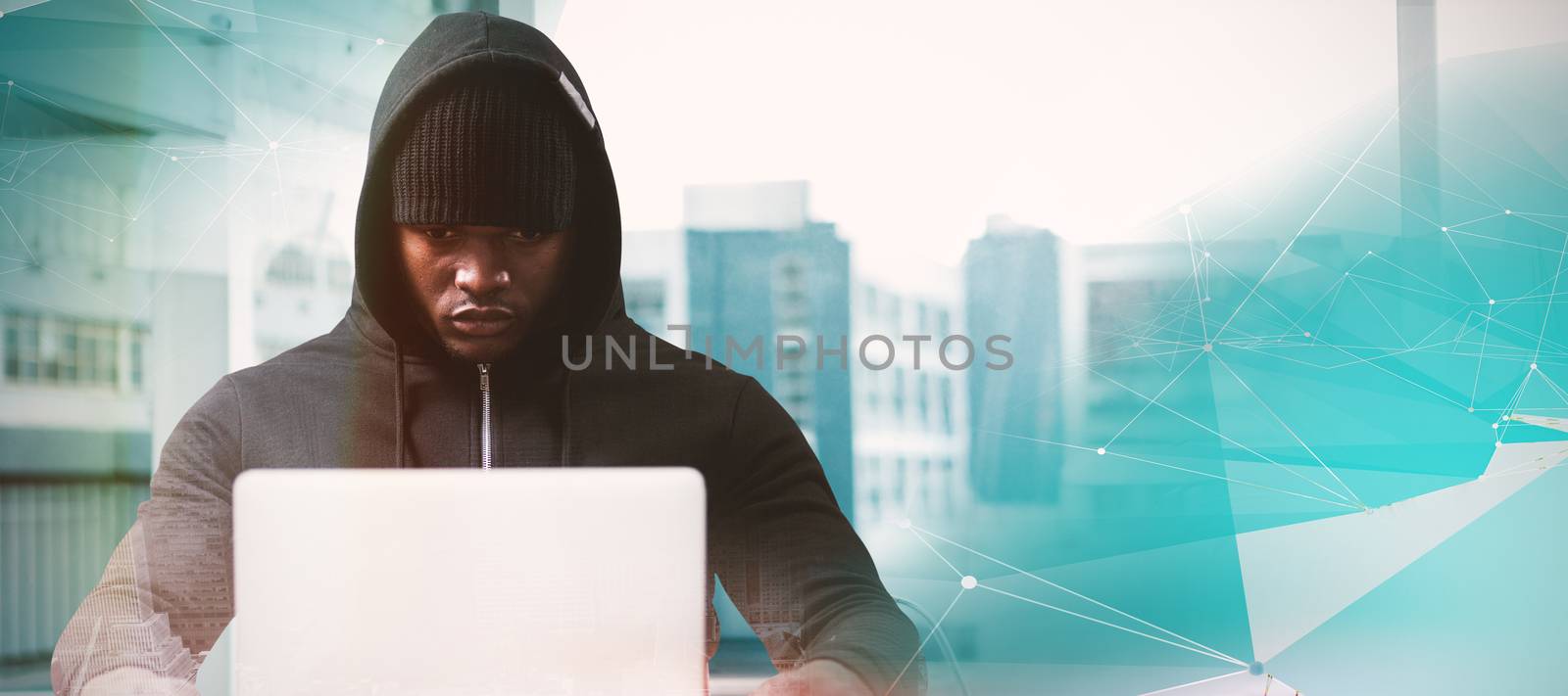 Composite image of serious male hacker with laptop  by Wavebreakmedia