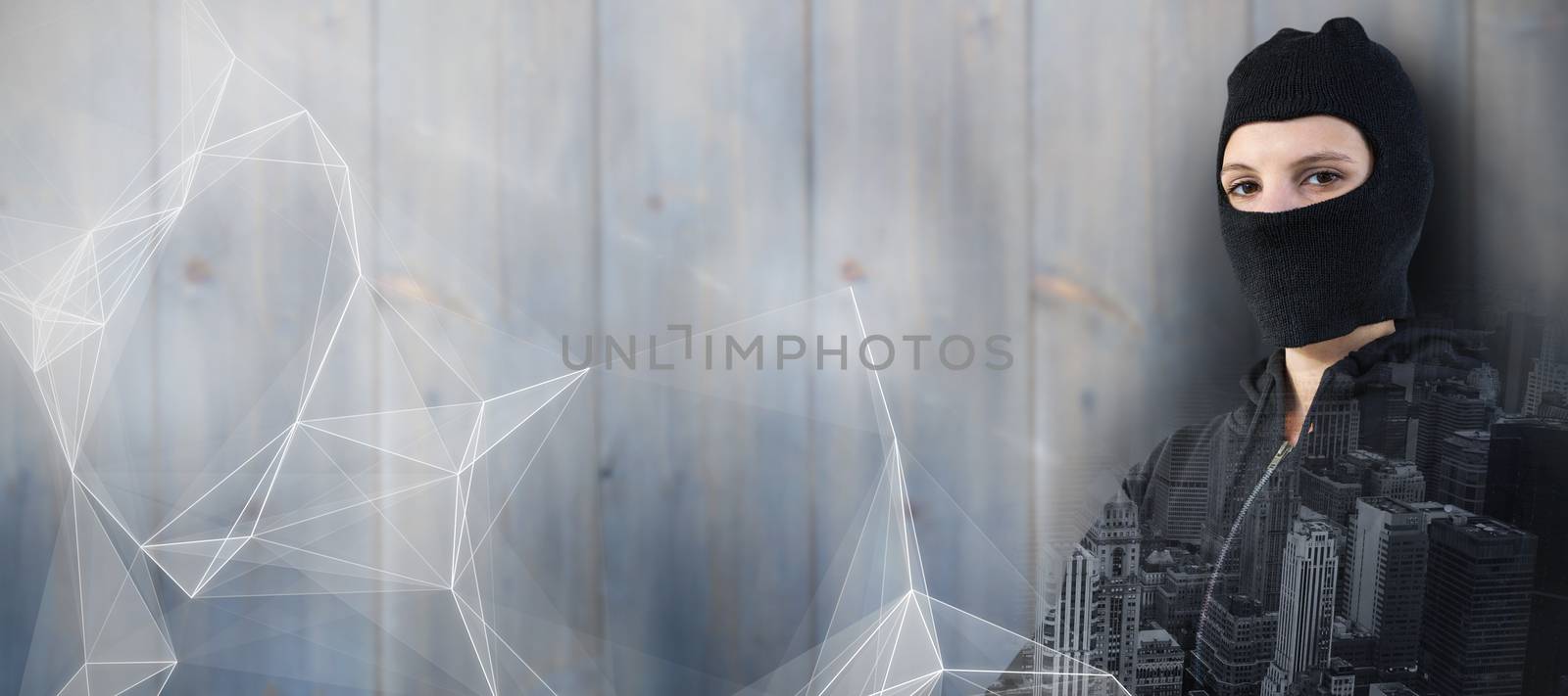 Portrait of female hacker standing with arms crossed against abstract black background