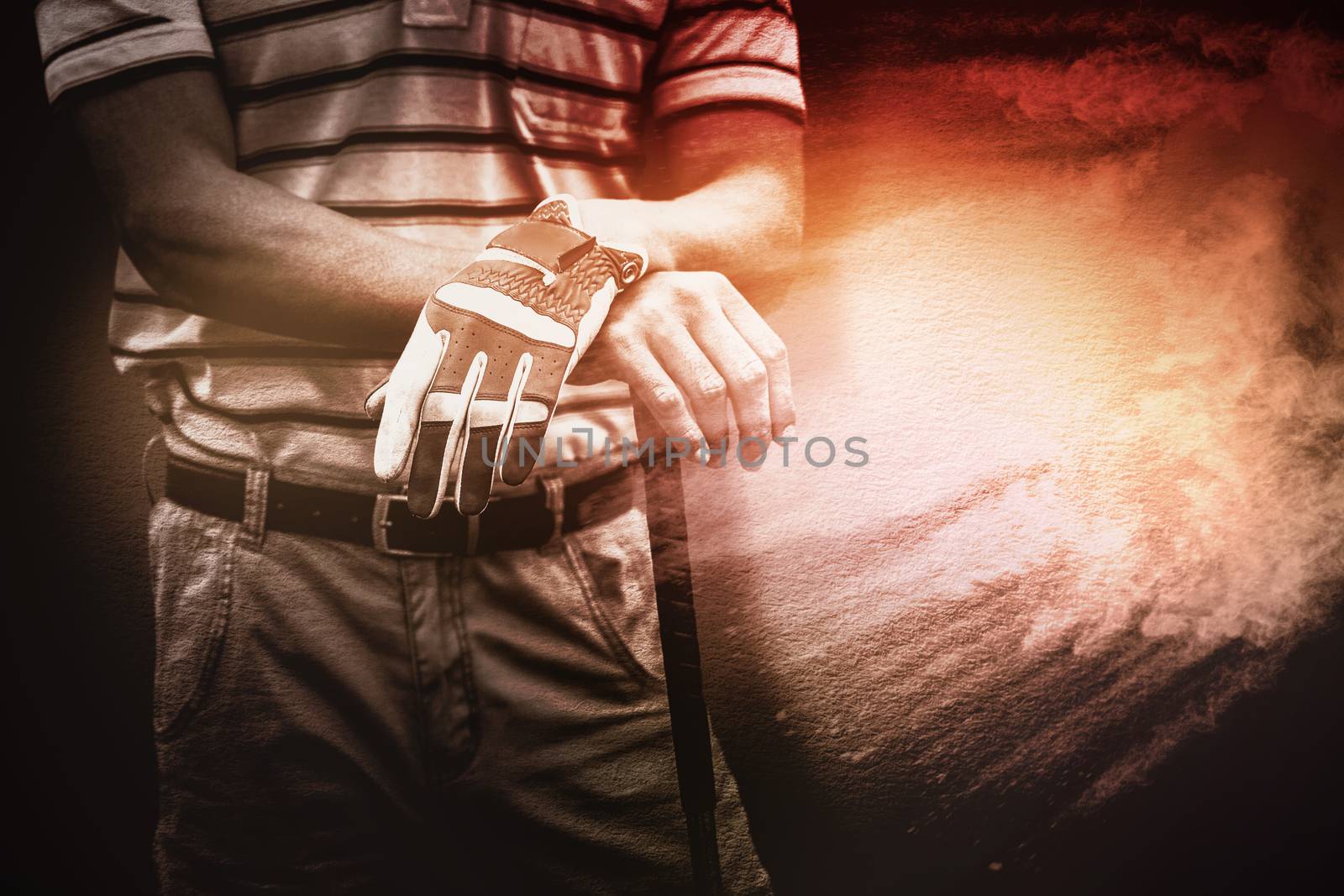 Man holding a golf club against beige background texture