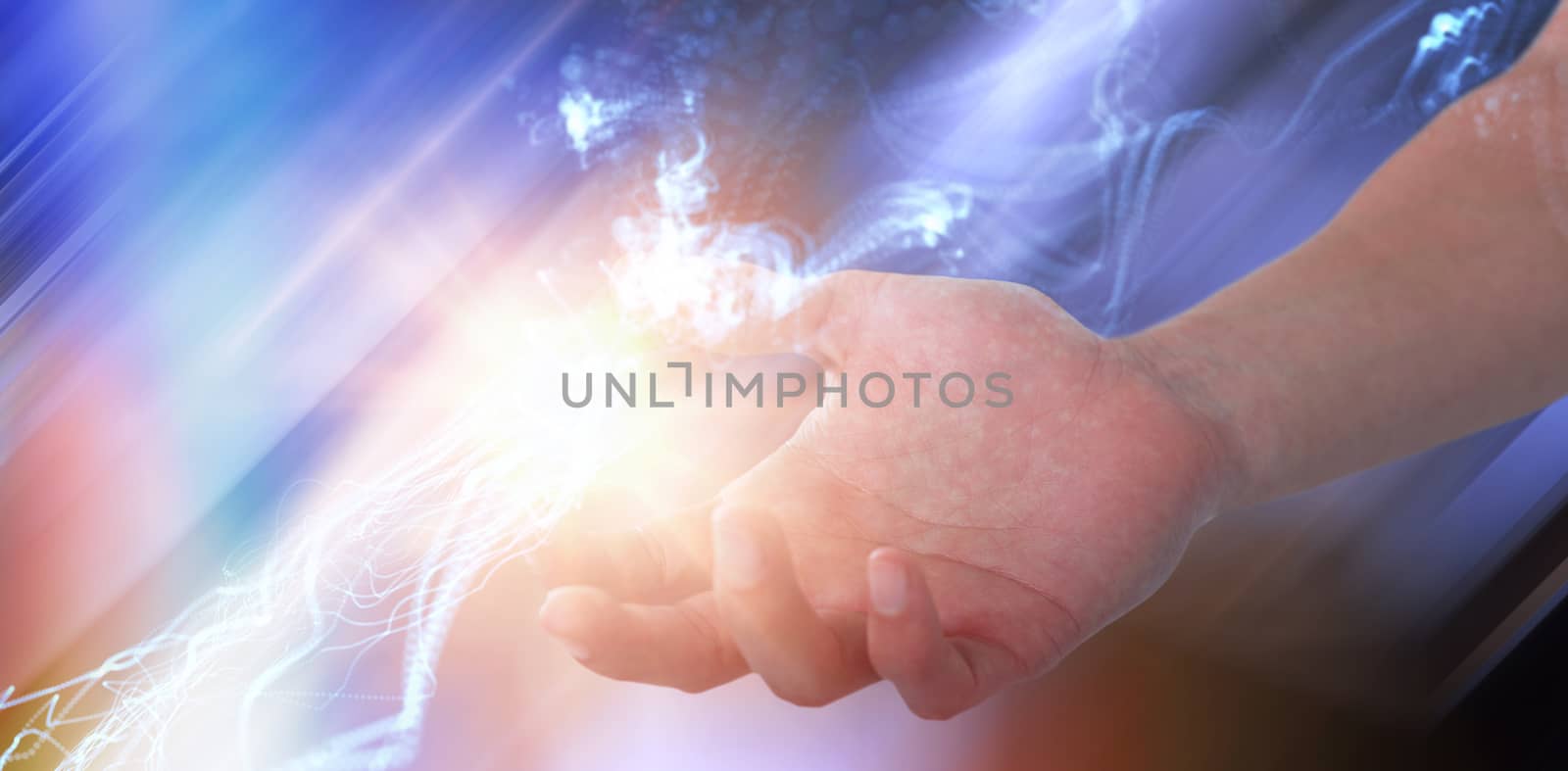 Hand of man pretending to hold an invisible object against abstract glowing black background