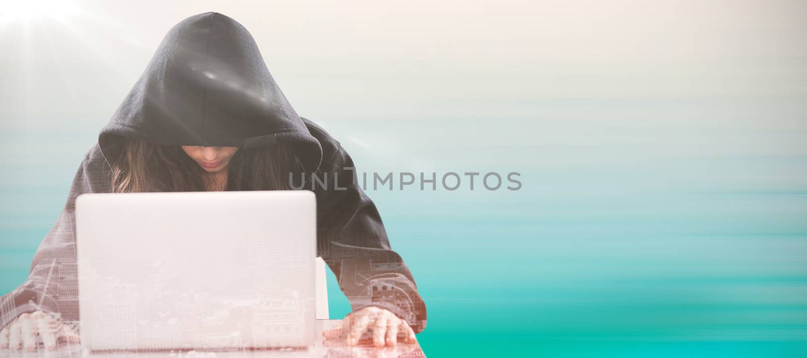 Female hacker sitting by laptop on table  against turquoise abstract backgrounds