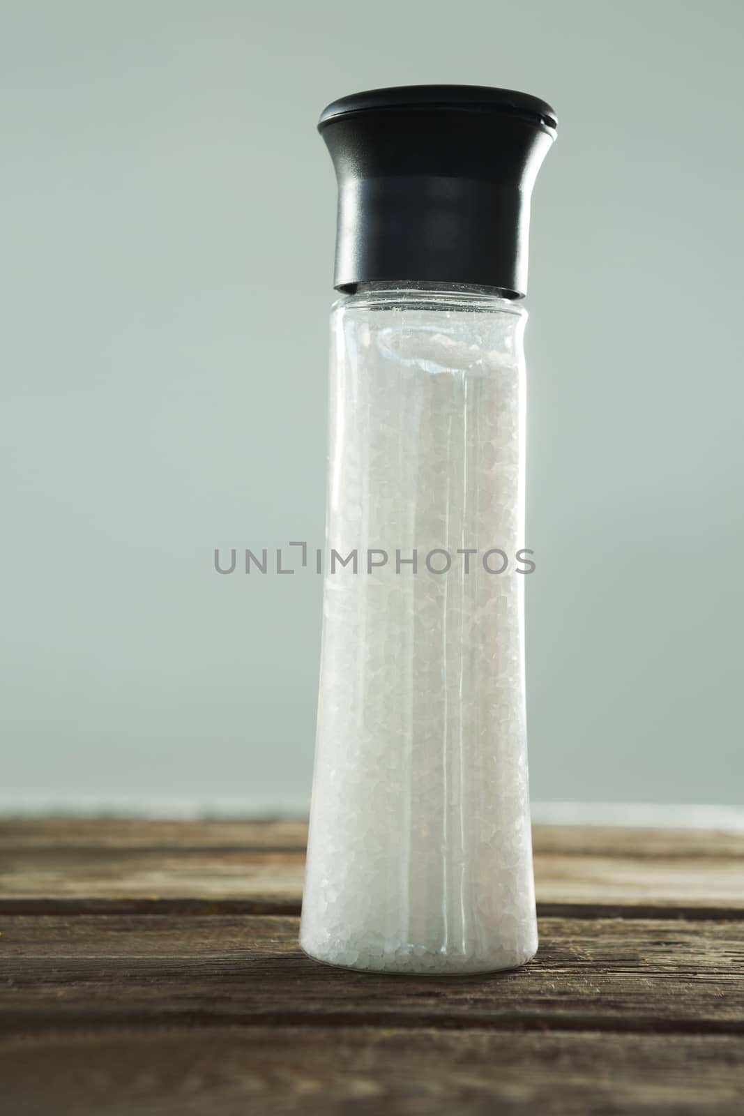 Salt shaker on wooden table by Wavebreakmedia