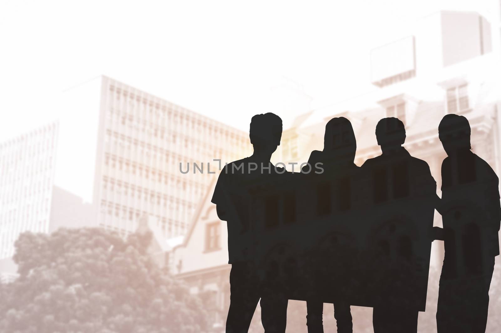 Digital composite of Business people silhouettes against city