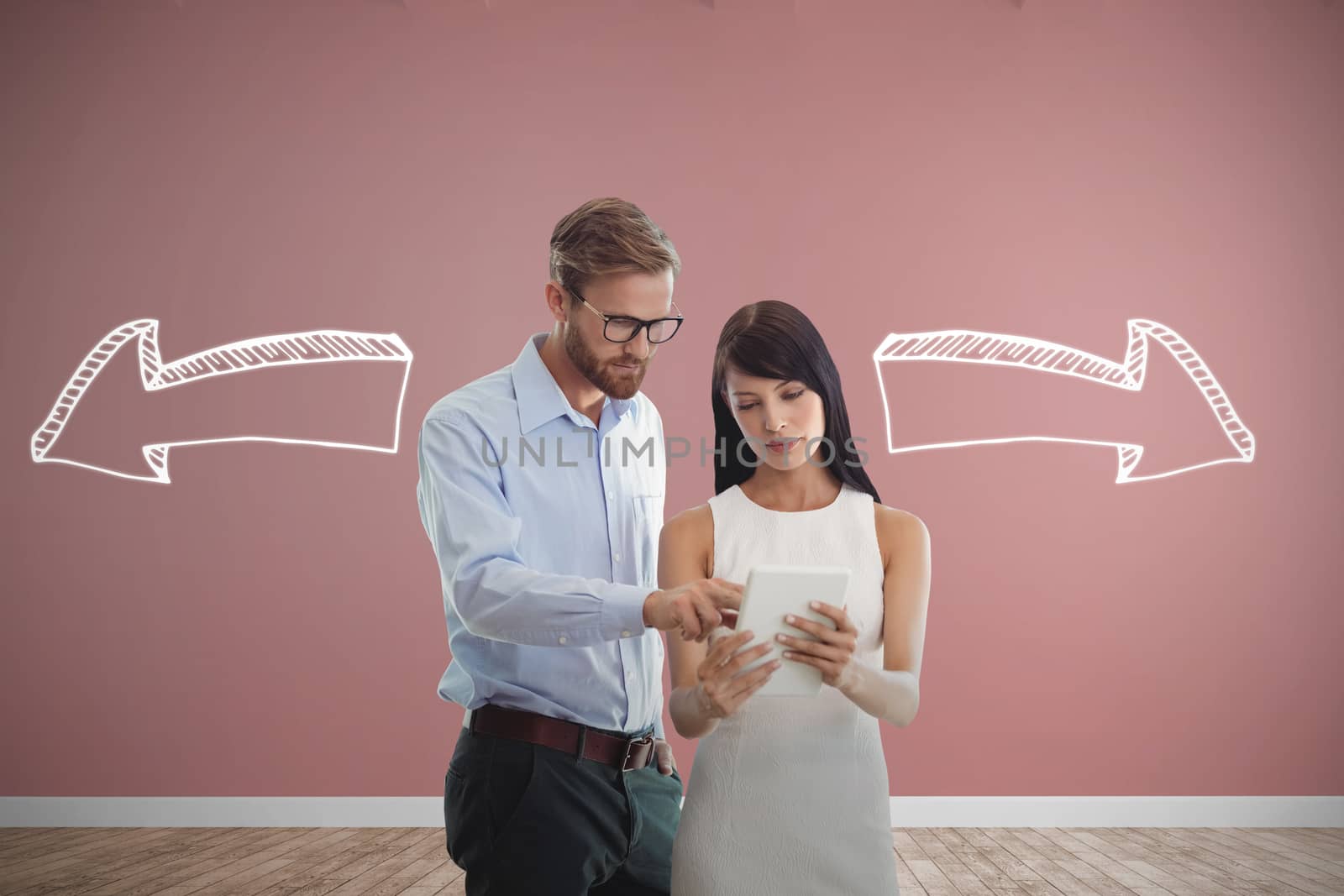 Business people looking at tablet against room with wooden floor