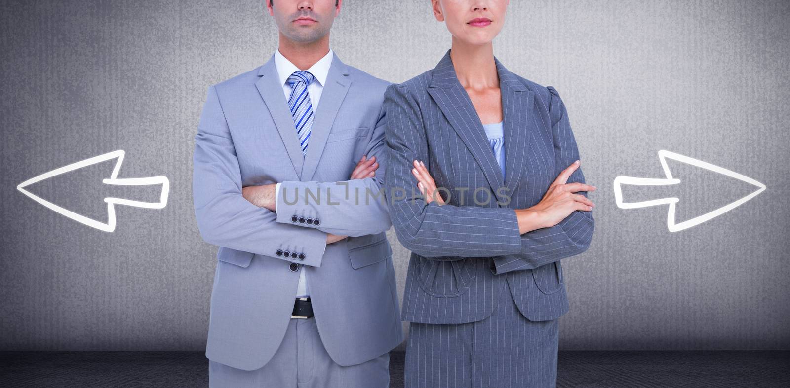 Business people with arms crossed looking at camera against grey room