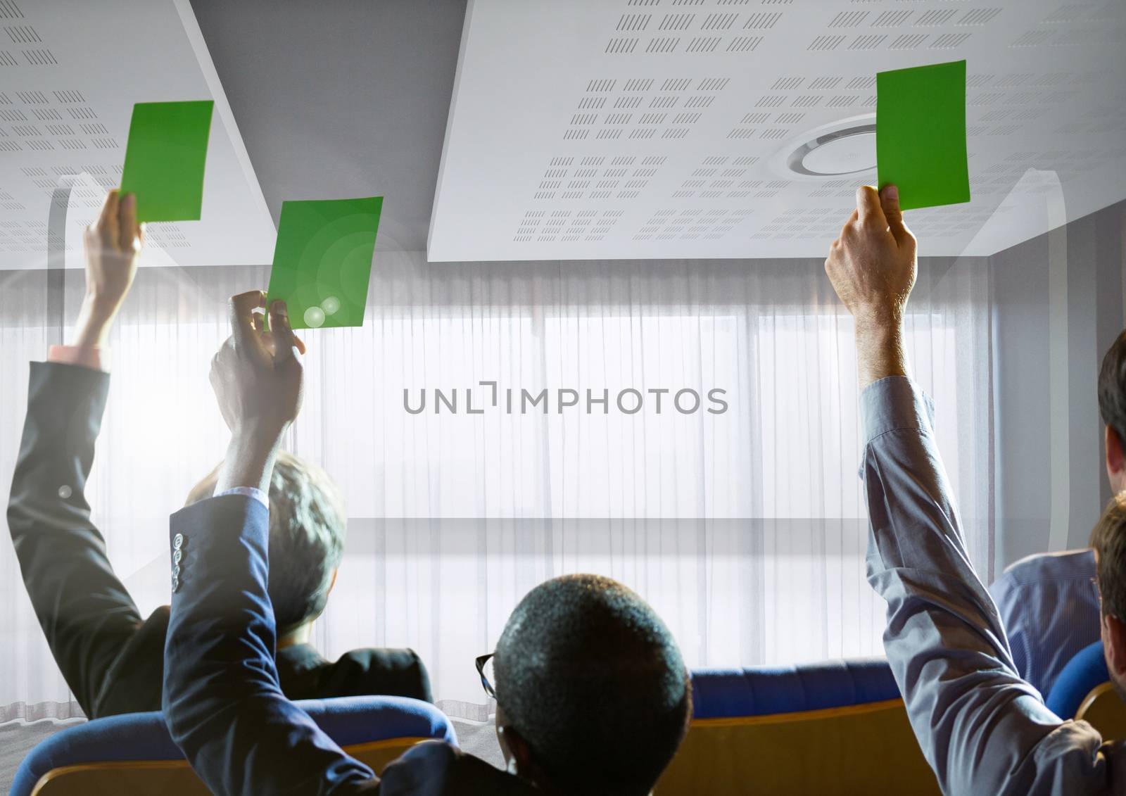 Business people holding green cards at conference by windows by Wavebreakmedia