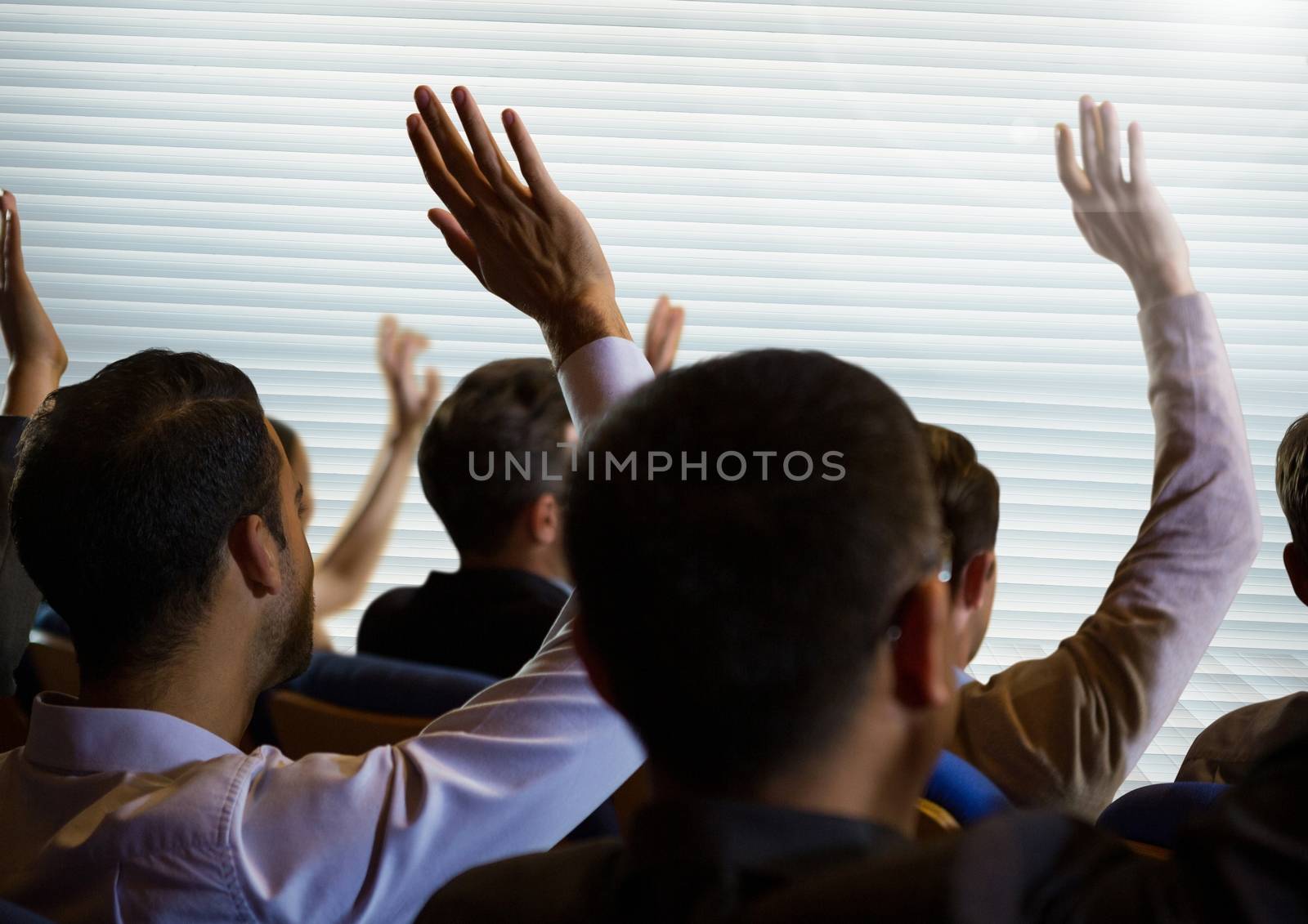 Business people with raised hands up by Wavebreakmedia