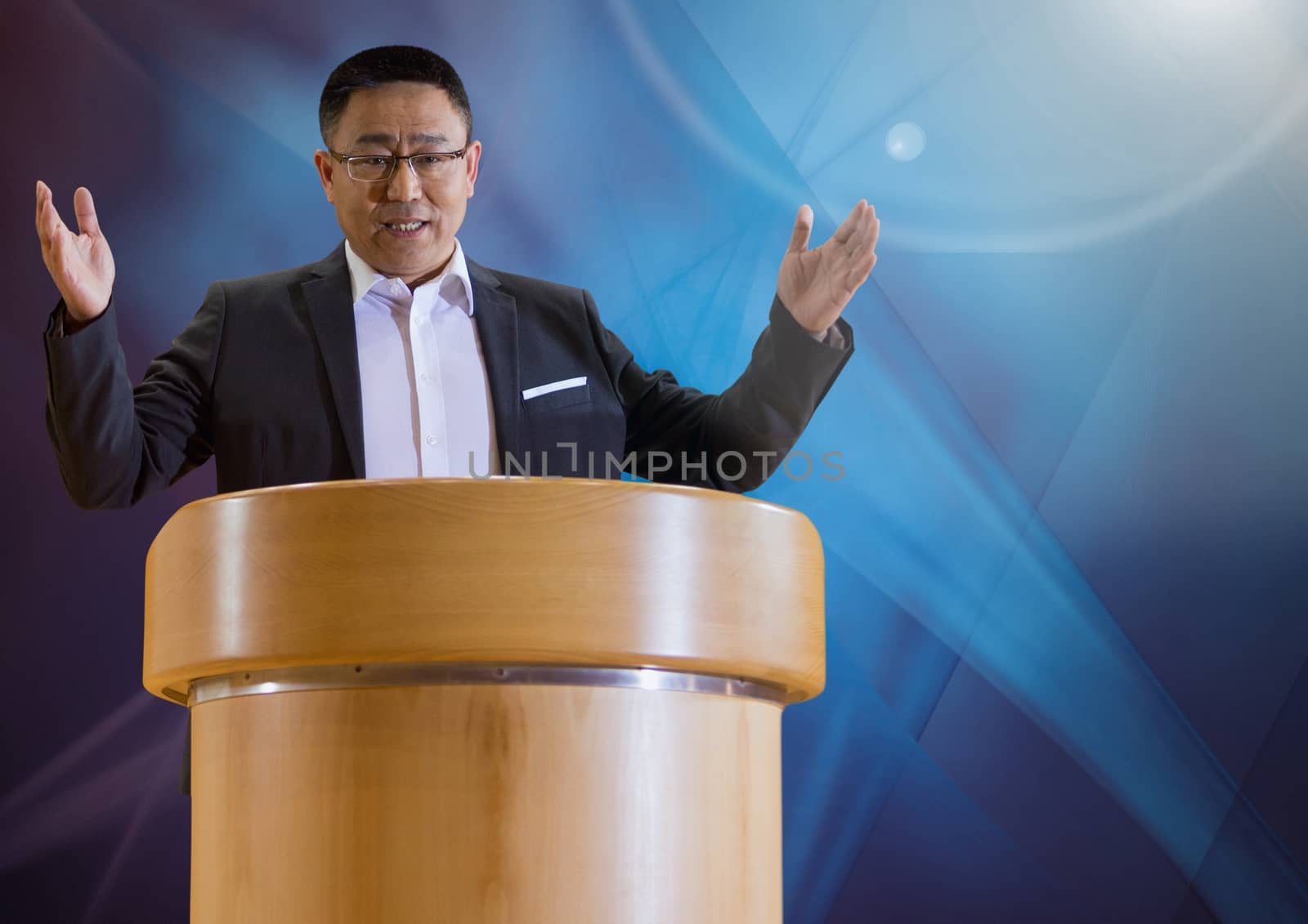 Digital composite of Businessman on podium speaking at conference with abstract background