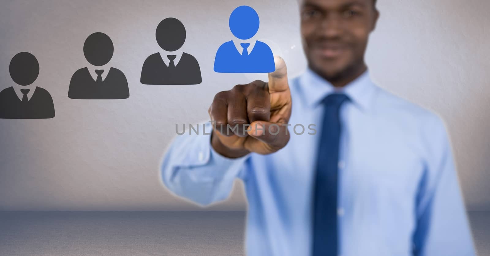 Digital composite of Businessman interacting and choosing a person from group of people icons