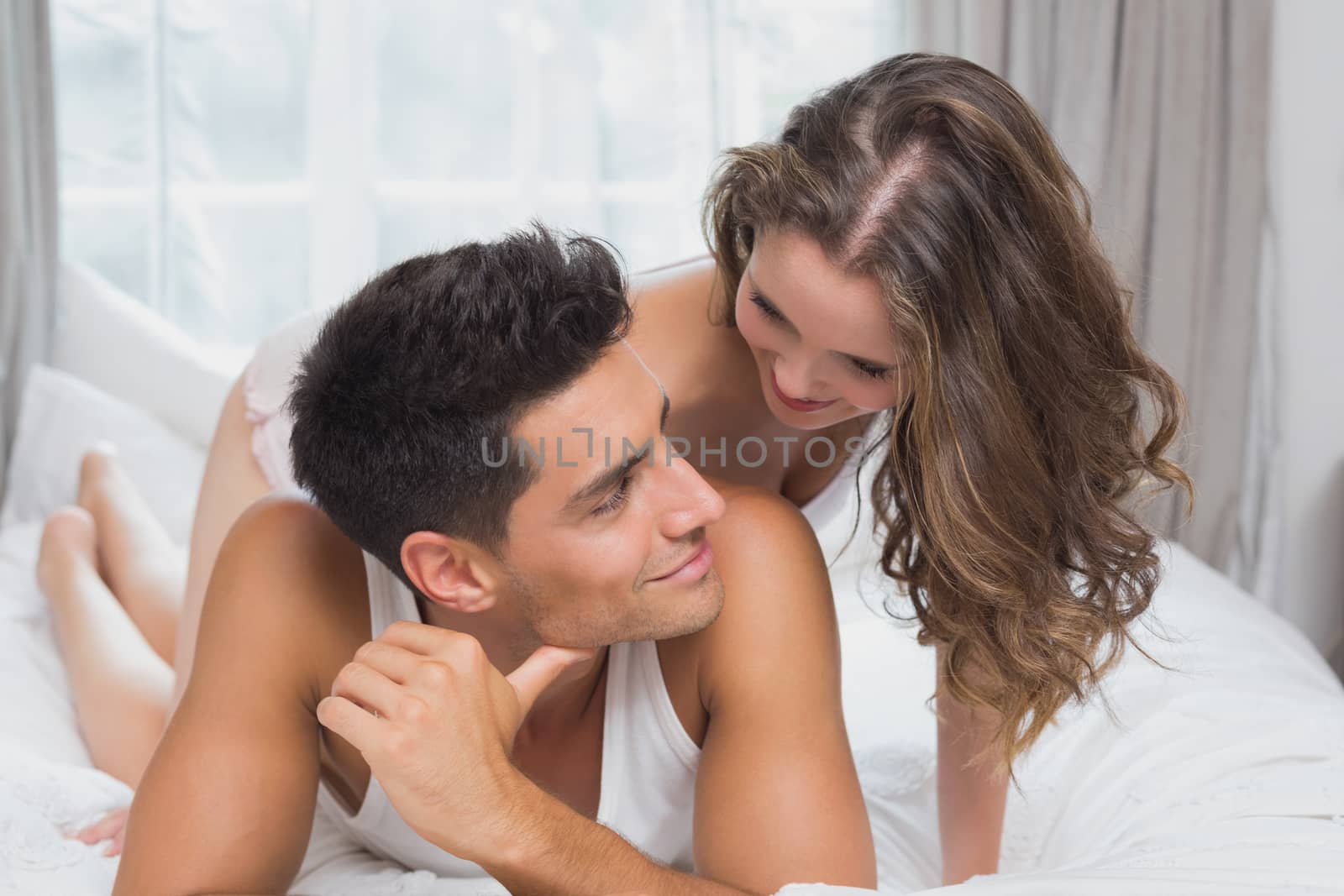 Close up portrait of romantic young couple in bed at home