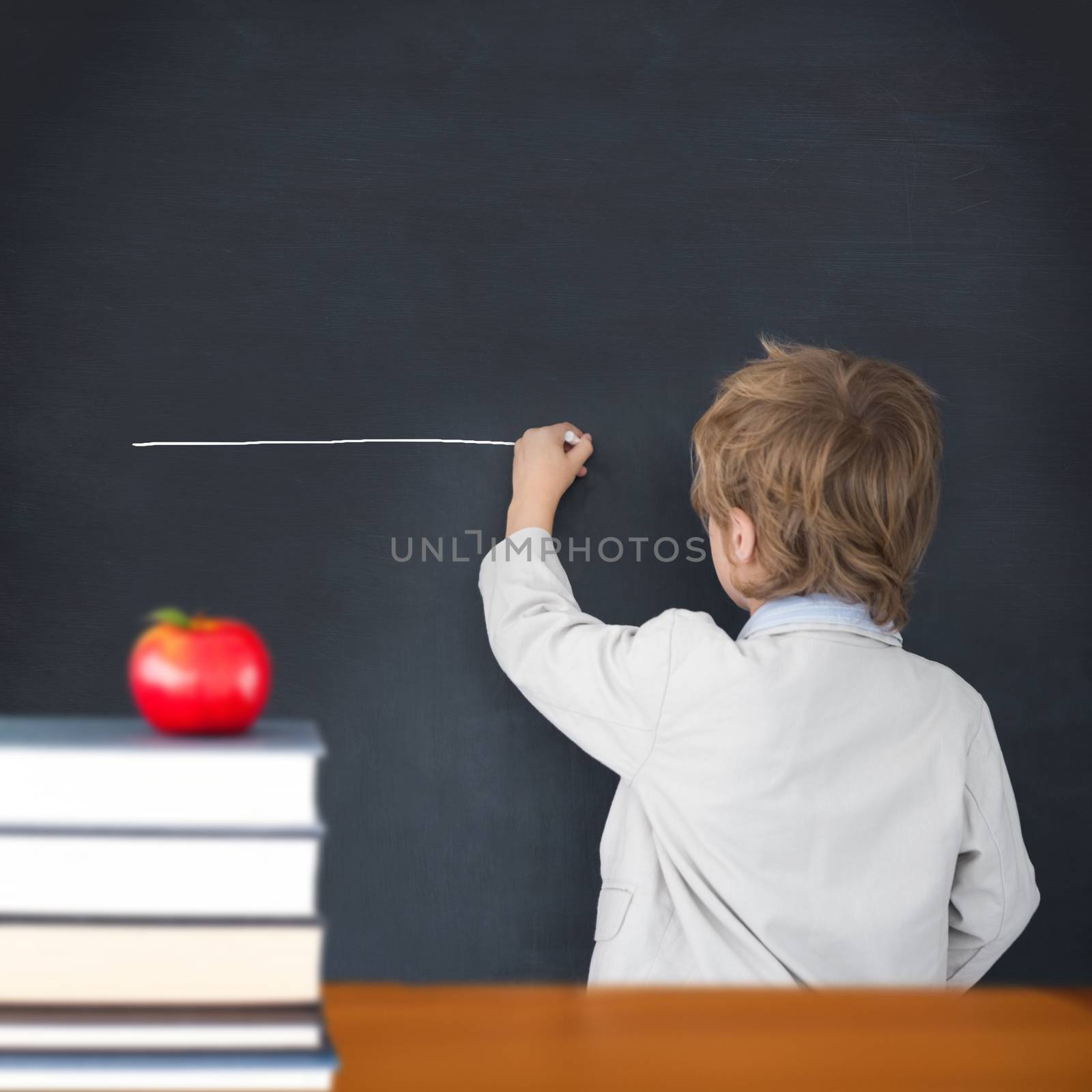 Composite image of cute pupil writing on board by Wavebreakmedia