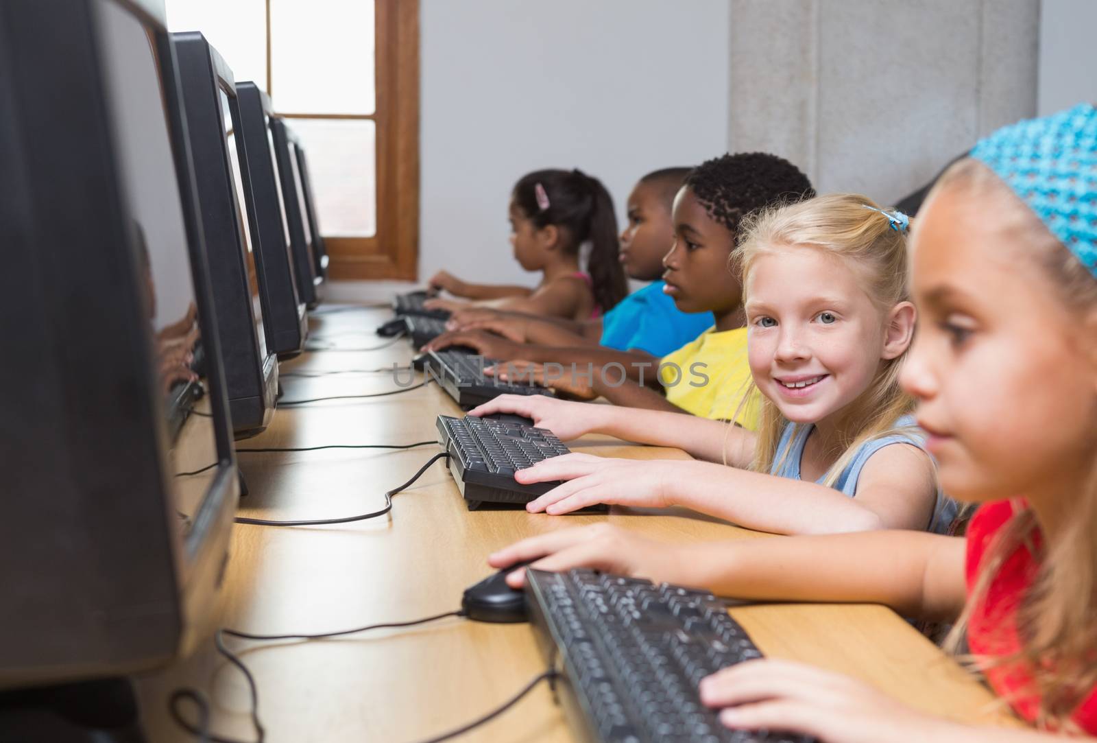 Cute pupils in computer class at the elementary school