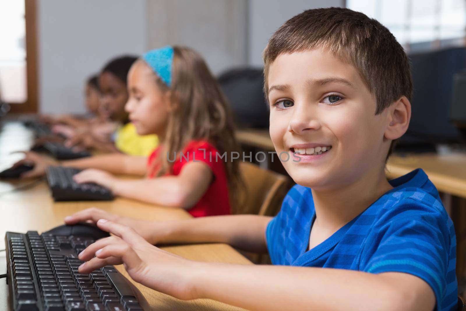 Cute pupils in computer class at the elementary school