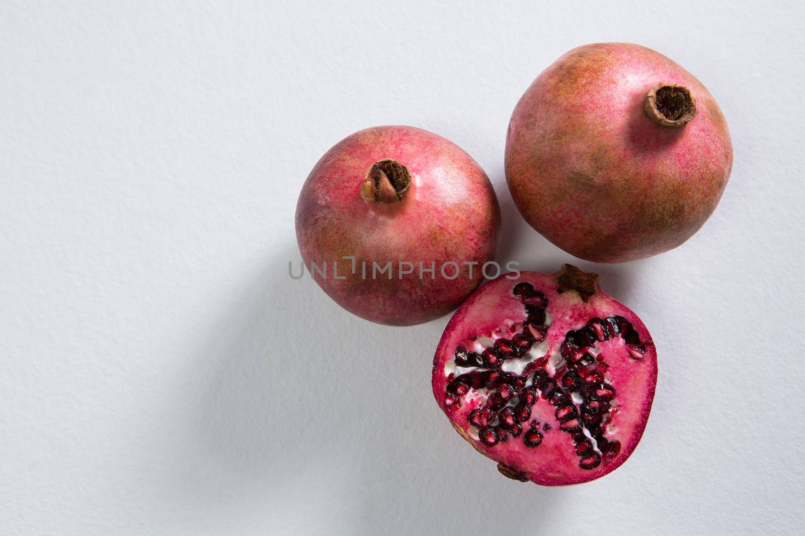 Pomegranates on a white background by Wavebreakmedia