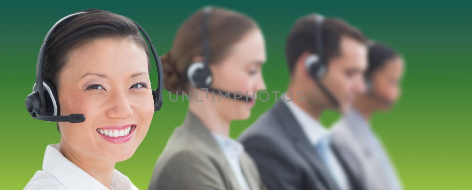 Business people with headsets using computers  against green abstract background