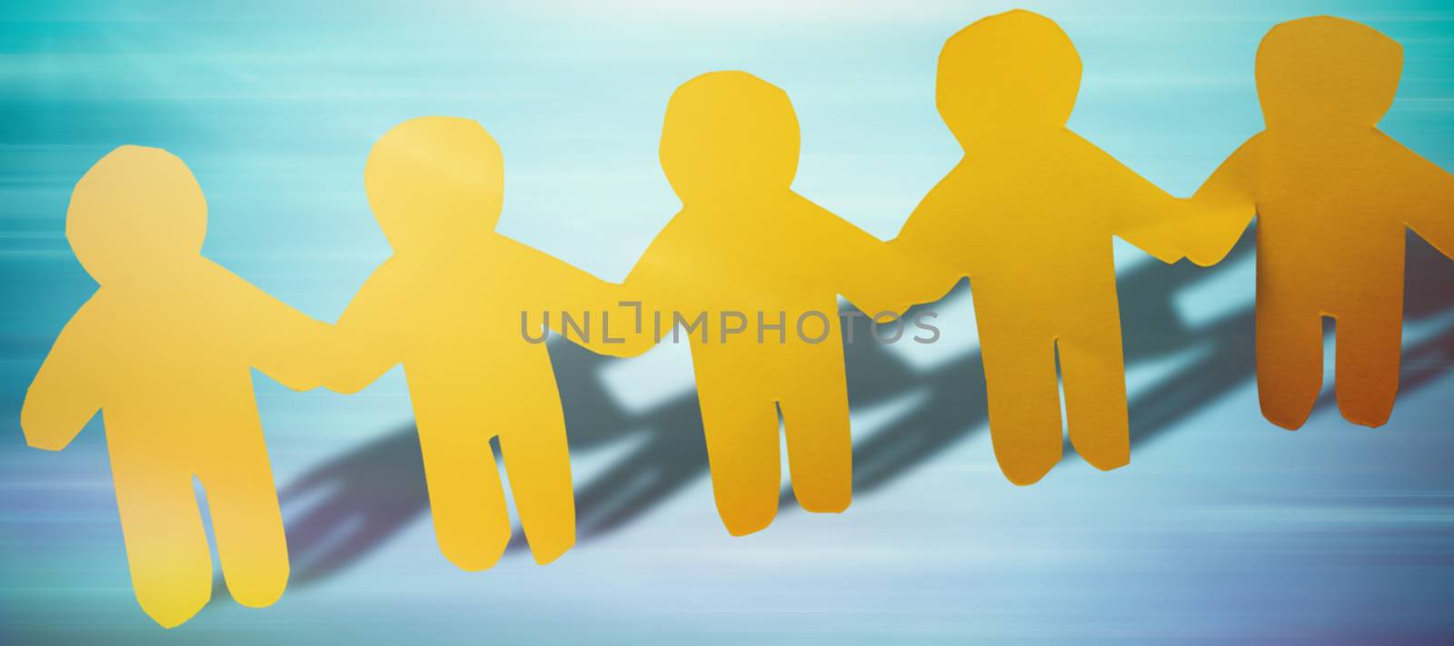 yellow hand holding paper against blue abstract image