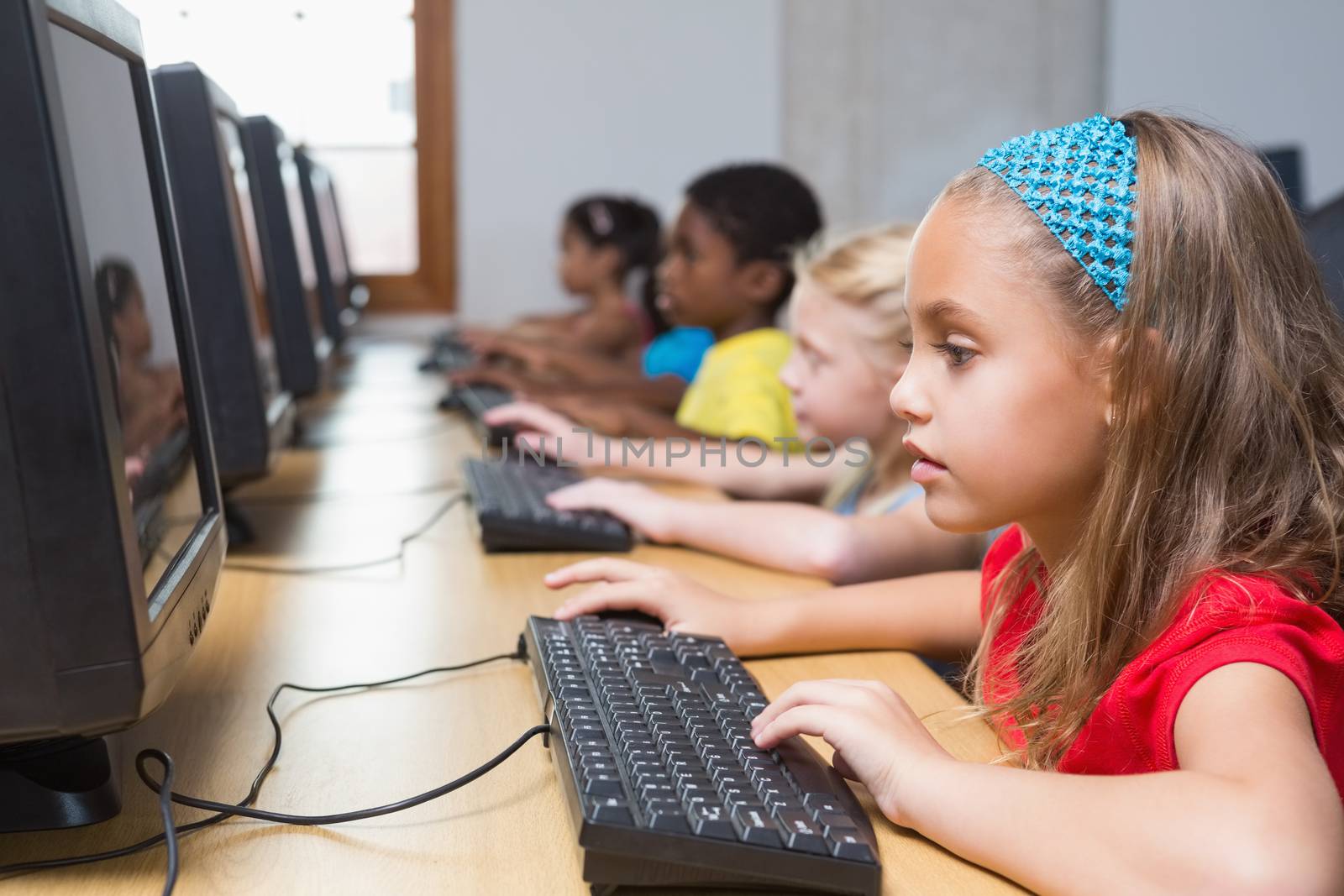 Cute pupils in computer class at the elementary school