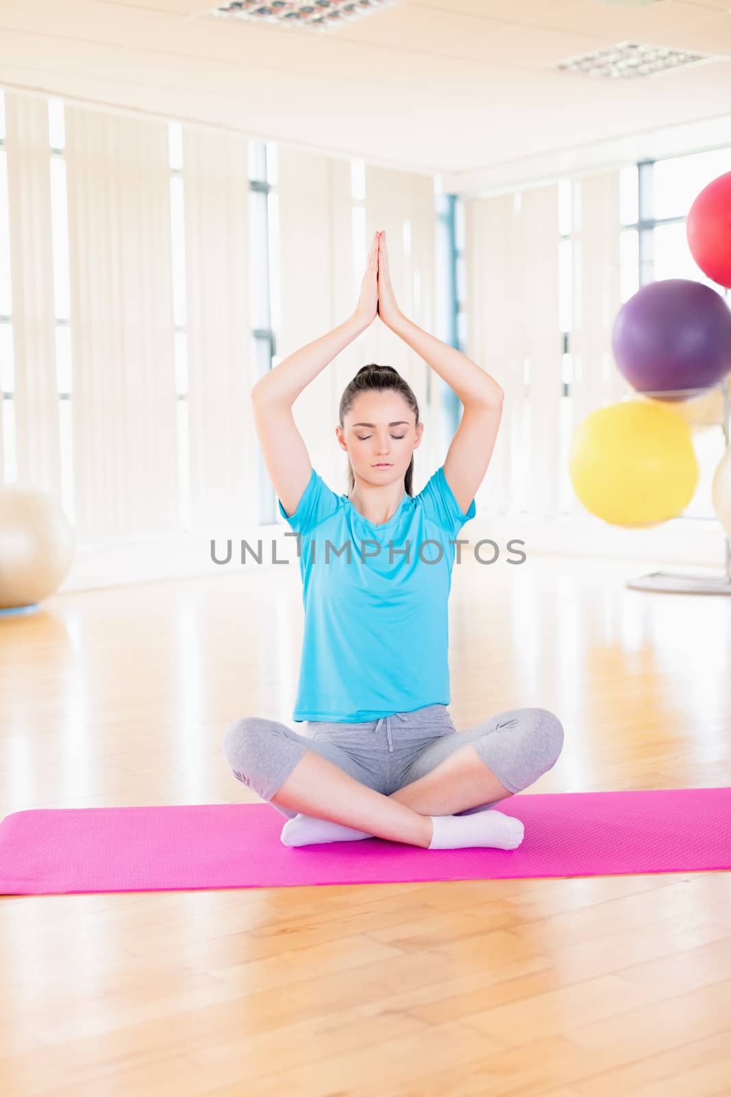 Young woman performing yoga in the gym