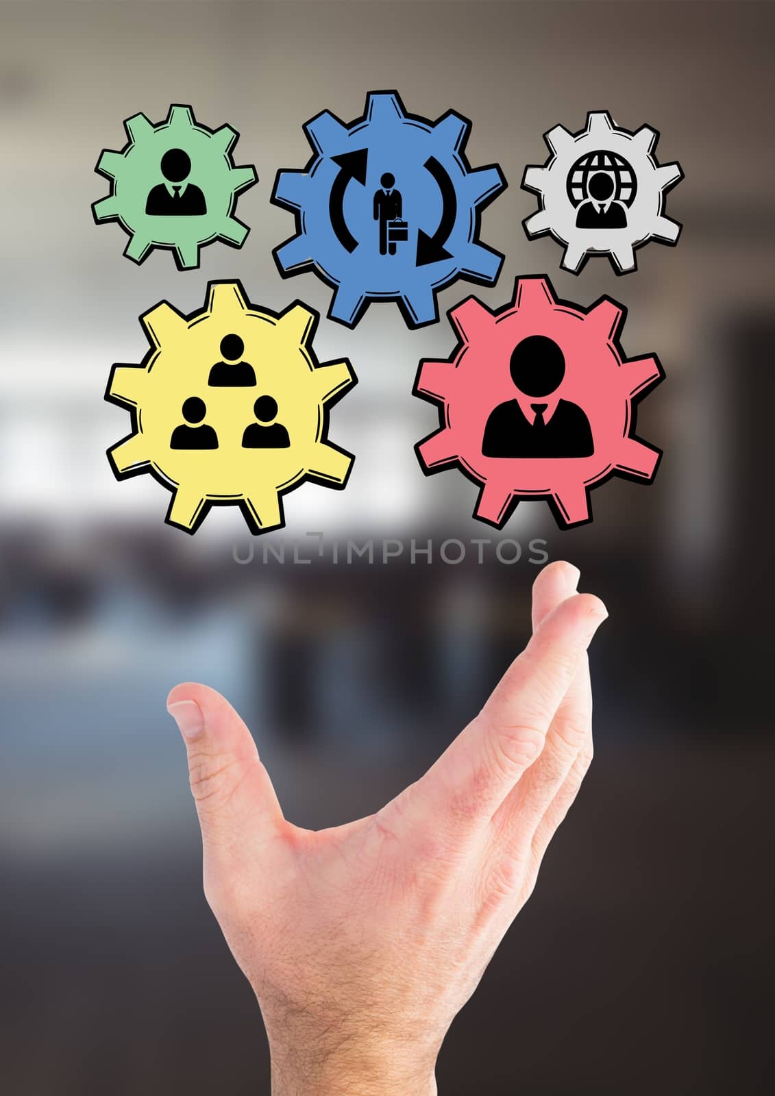 Digital composite of Hand interacting with people in cogs graphics against office background