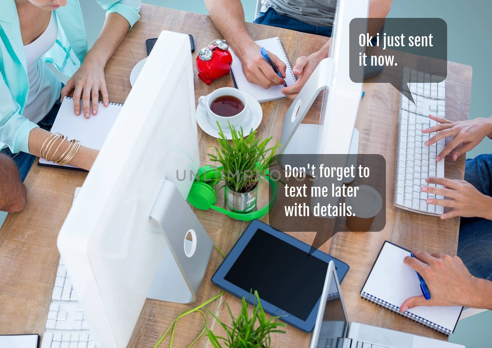 People working in office at desk with chat bubble at meeting by Wavebreakmedia