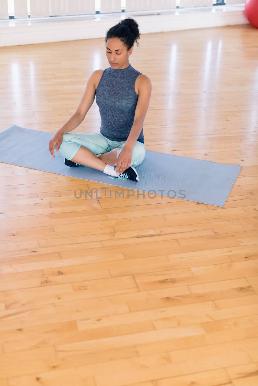 Young woman performing yoga in the gym