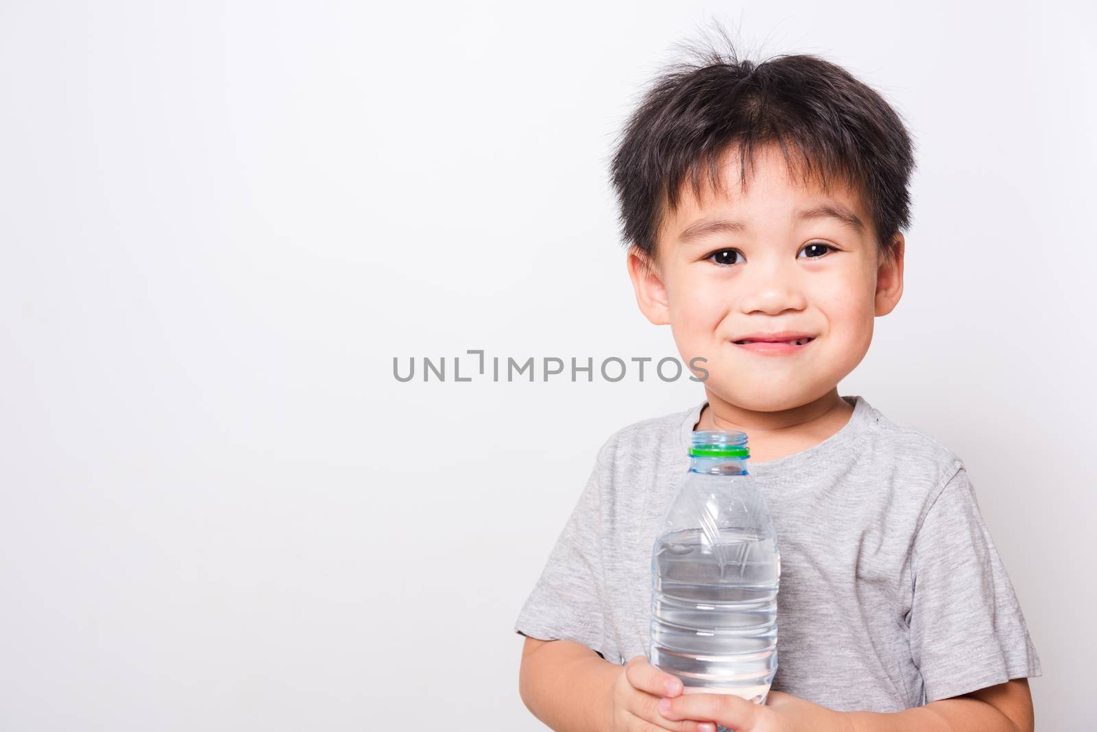 Closeup Asian face, Little children boy drinking water from Plastic bottle on white background with copy space, health medical care