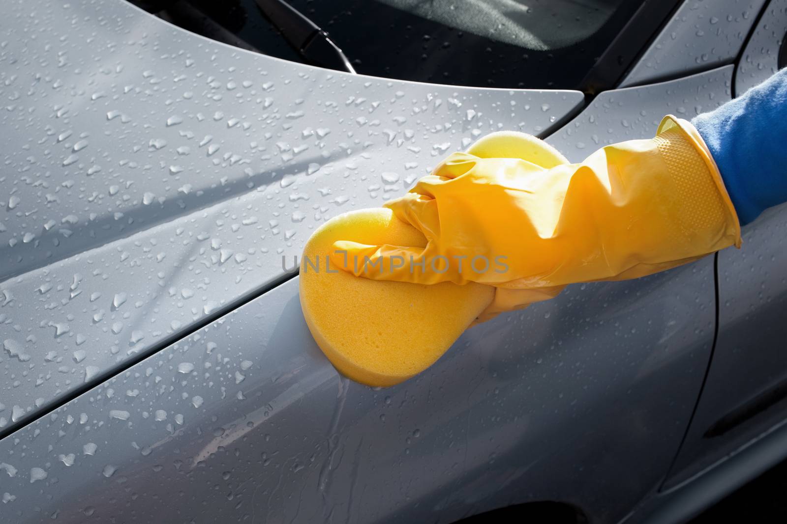 Cropped image of woman cleaning her car by Wavebreakmedia