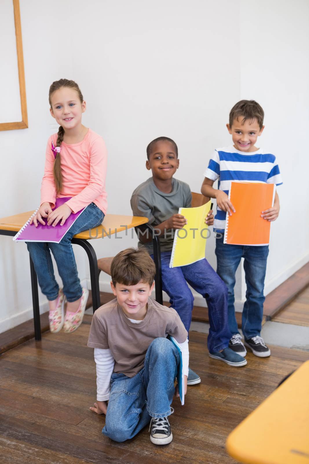 Classmates smiling together in classroom at the elementary school