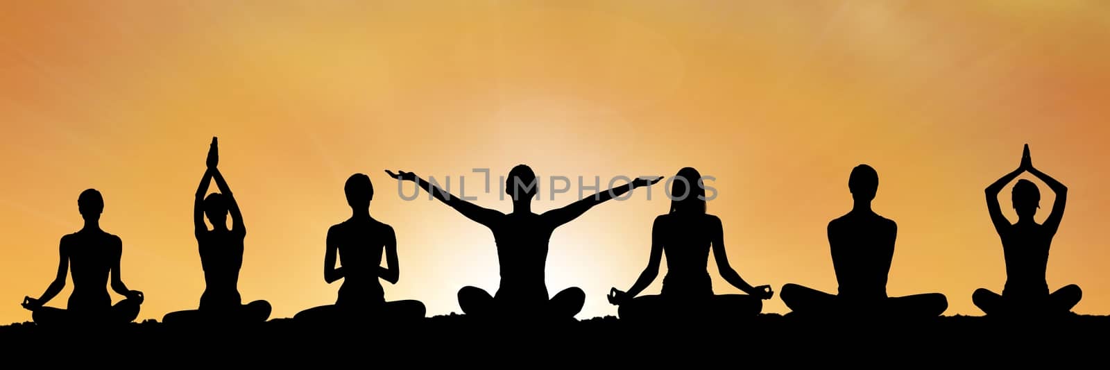 yoga group silhouette at sunset by Wavebreakmedia