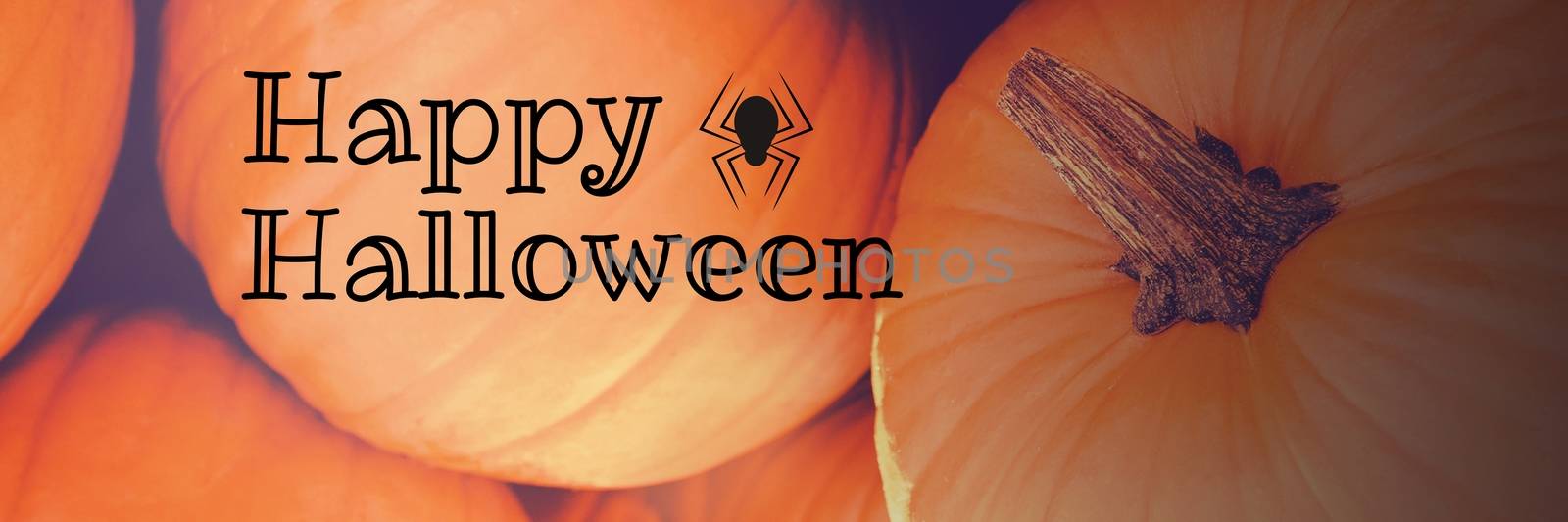 Digital composite of Happy Halloween text with pumpkins