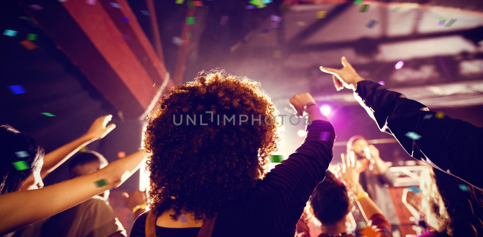 Flying colours against people enjoying music concert at nightclub