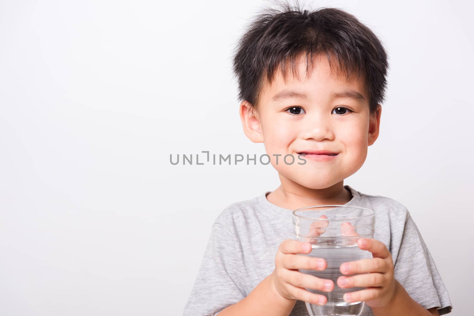 Closeup Asian face, Little children boy drinking water from glas by Sorapop