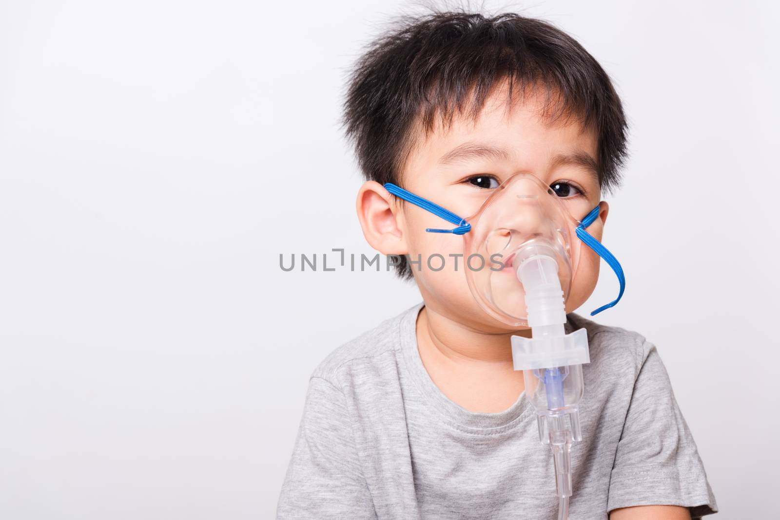 Closeup Asian face, Little children boy sick he using steam inhaler nebulizer mask inhalation oneself on white background, health medical care