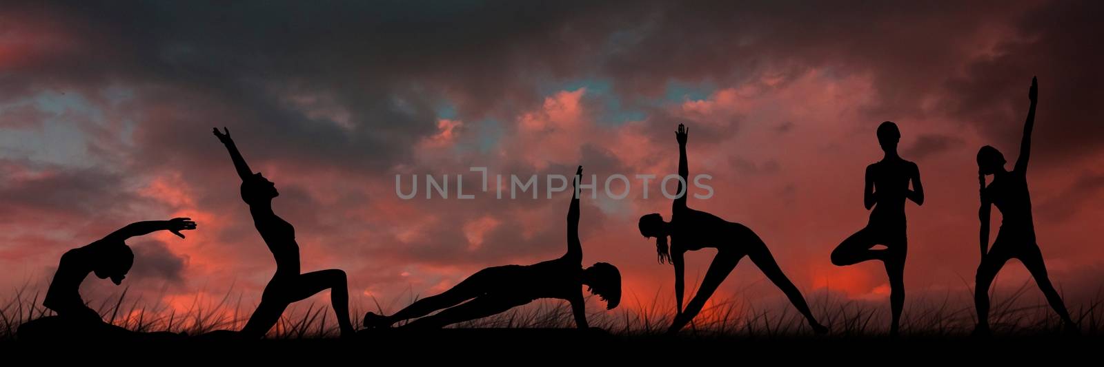 yoga group silhouette at sunset by Wavebreakmedia