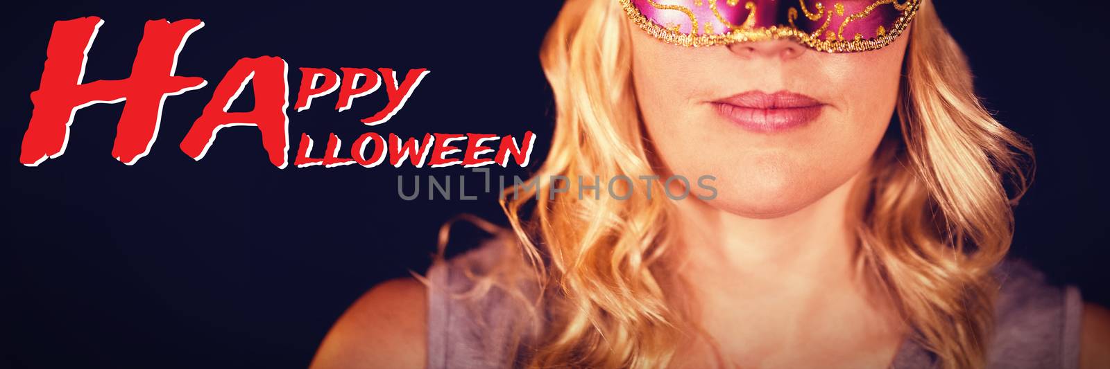 Graphic image of Happy Halloween text against portrait of woman in masquerade mask 